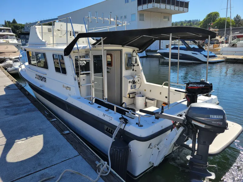 Slide: The Image of 2001 SeaSport 2700 Navigator boat docked at marina with Yamaha and Mercury engines. - 9