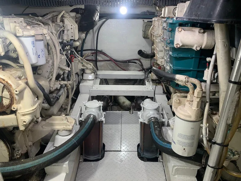 Slide: The Image of Engine room of a 1997 Henriques 38 Sportfisherman, showcasing dual engines and mechanical components. - 4
