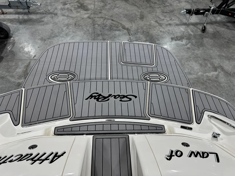 Slide: The Image of 2005 Sea Ray 290 SLX boat with custom gray decking in a showroom. - 11