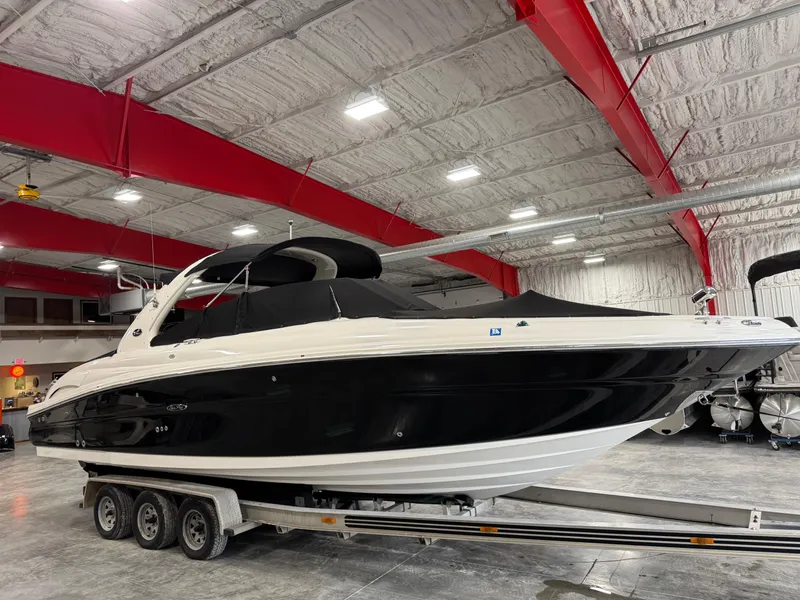 Slide: The Image of 2005 Sea Ray 290 SLX boat on trailer in indoor storage facility. - 12
