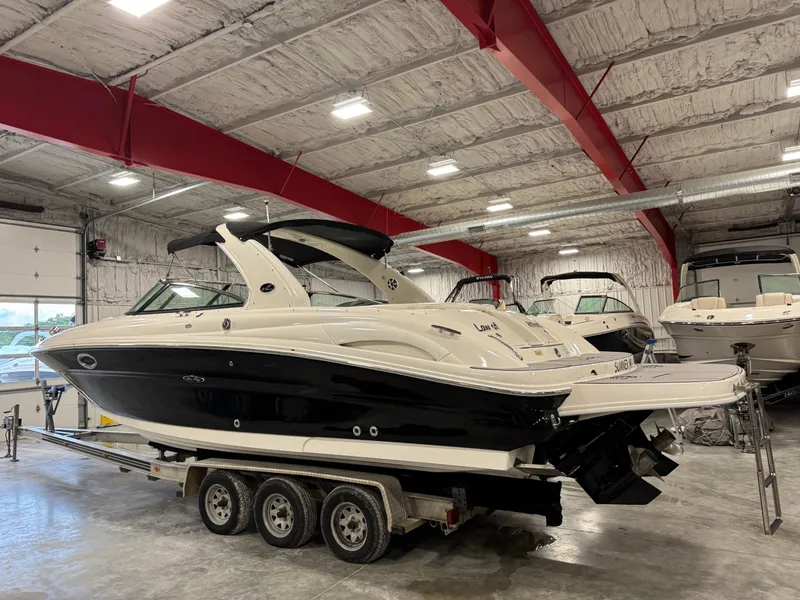 Slide: The Image of 2005 Sea Ray 290 SLX boat on trailer in indoor storage facility. - 4