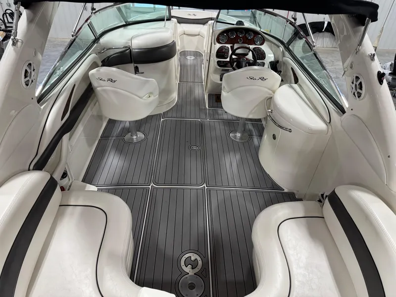 Slide: The Image of 2005 Sea Ray 290 SLX boat interior with white seating and sleek dashboard. - 6