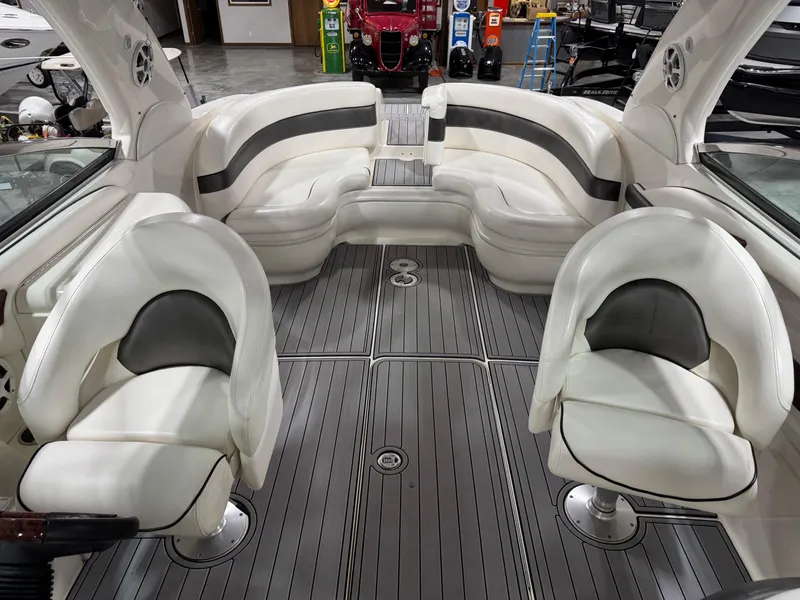 Slide: The Image of 2005 Sea Ray 290 SLX boat interior with white seating and gray flooring. - 8