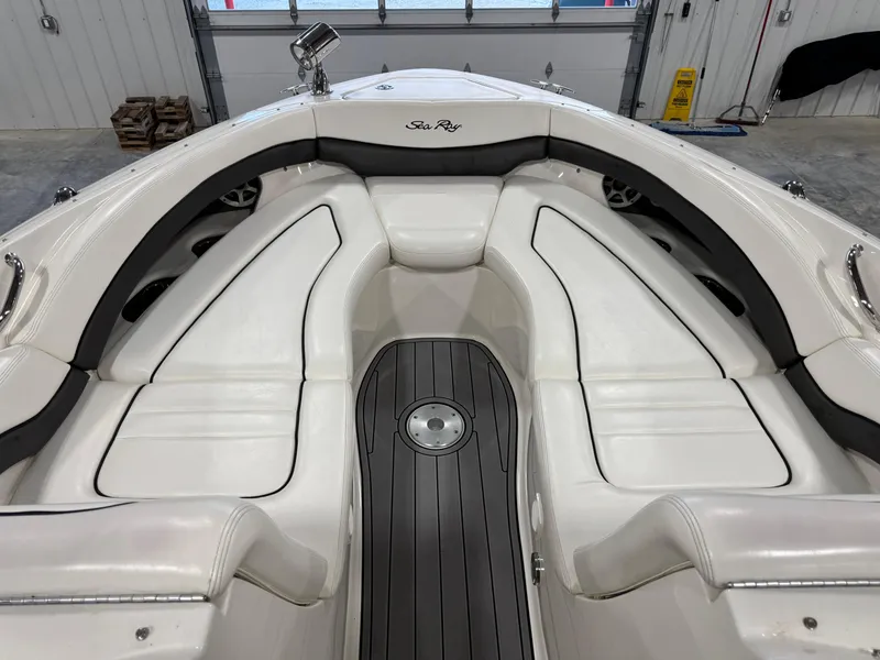 Slide: The Image of Interior view of 2005 Sea Ray 290 SLX boat with white seating and sleek design. - 9