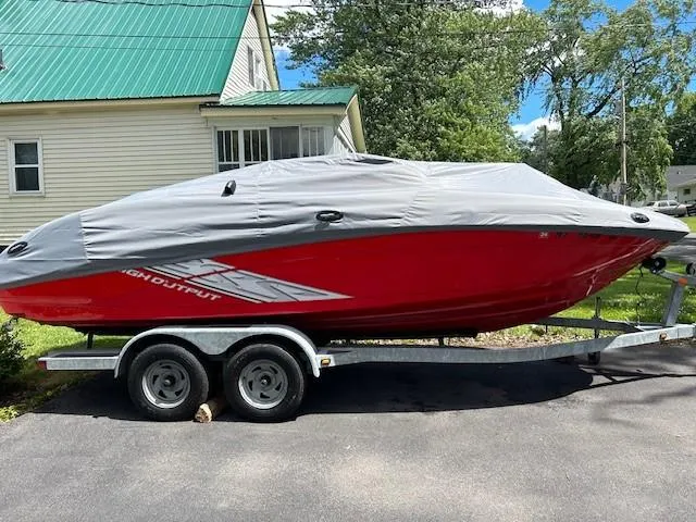 Slide: The Image of 2008 Yamaha Jet Boat covered on trailer, parked in driveway near house. - 3