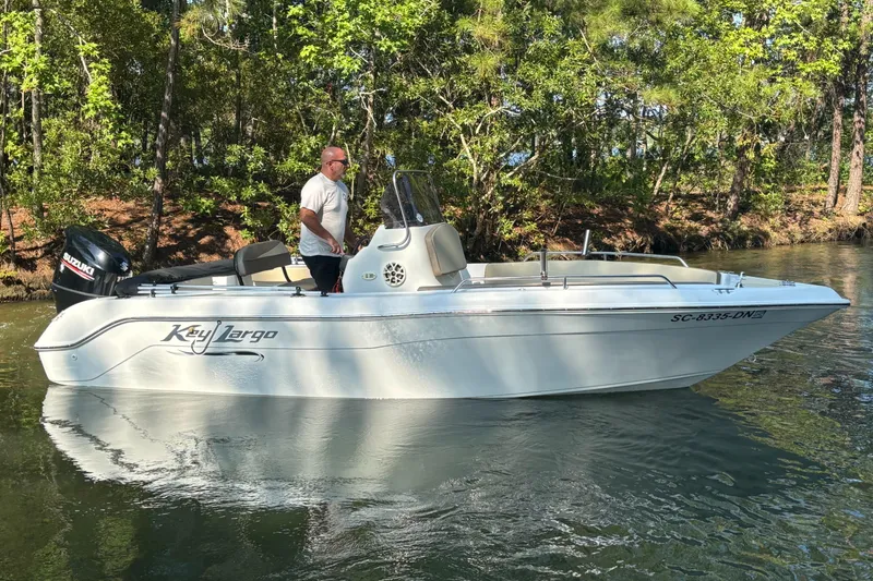 Slide: The Image of Man on 2019 Key Largo 2000 boat with Suzuki engine, cruising on a calm river. - 3