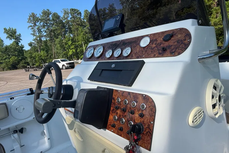 Slide: The Image of Key Largo 2000 boat dashboard with steering wheel and gauges, 2019 model. - 5