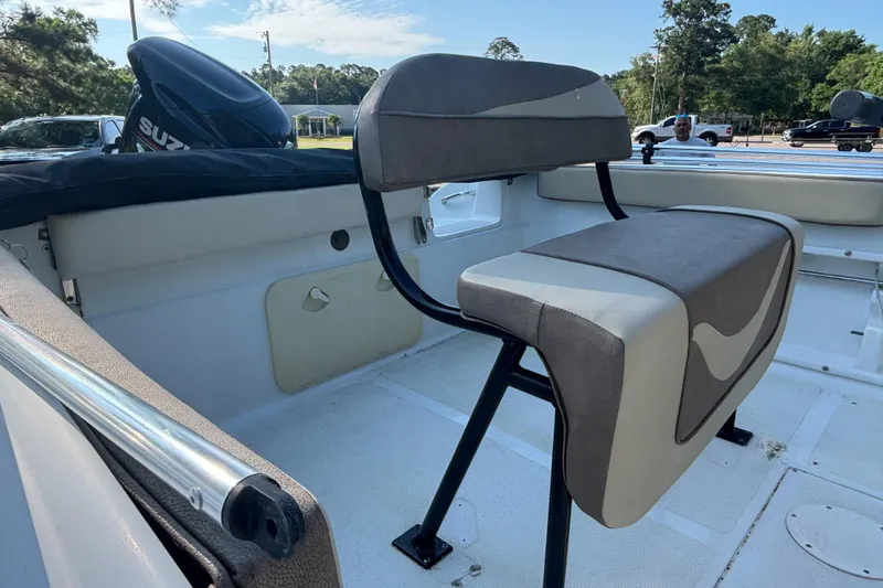 Slide: The Image of Interior of a 2019 Key Largo 2000 boat with seating and Suzuki outboard motor. - 7