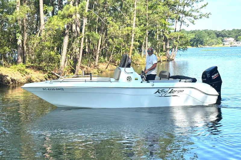 Slide: The Image of Man on 2019 Key Largo 2000 boat in a serene lake setting. - 8
