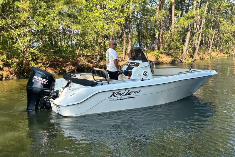 Slide: The Image of A 2019 Key Largo 2000 boat with Suzuki engine on a calm river. - 9
