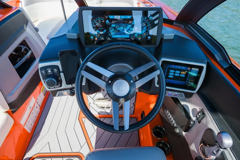 Slide: The Image of 2018 Malibu Wakesetter 24 MXZ dashboard with modern controls and touchscreen displays. - 11