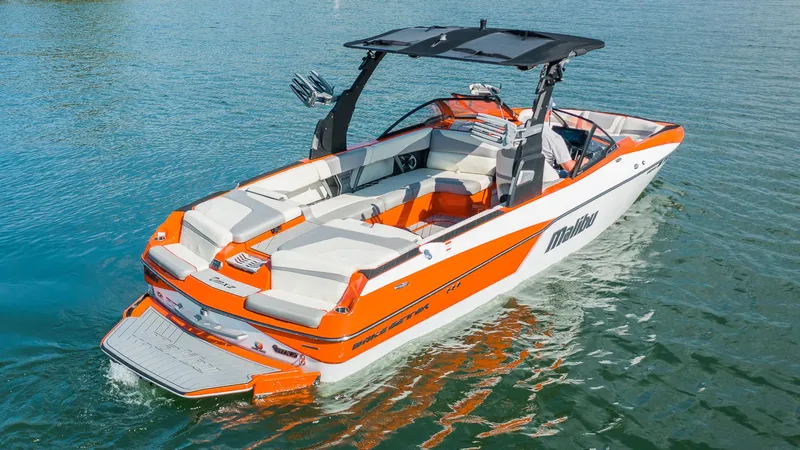 Slide: The Image of 2018 Malibu Wakesetter 24 MXZ boat on water, featuring orange and white design. - 3