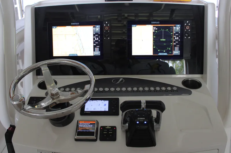 Slide: The Image of 2018 Jupiter 30 HFS boat dashboard with dual Simrad displays and Yamaha controls. - 4
