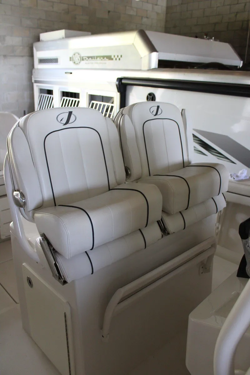 Slide: The Image of 2018 Jupiter 30 HFS boat with white cushioned seats in a sleek, modern design. - 8