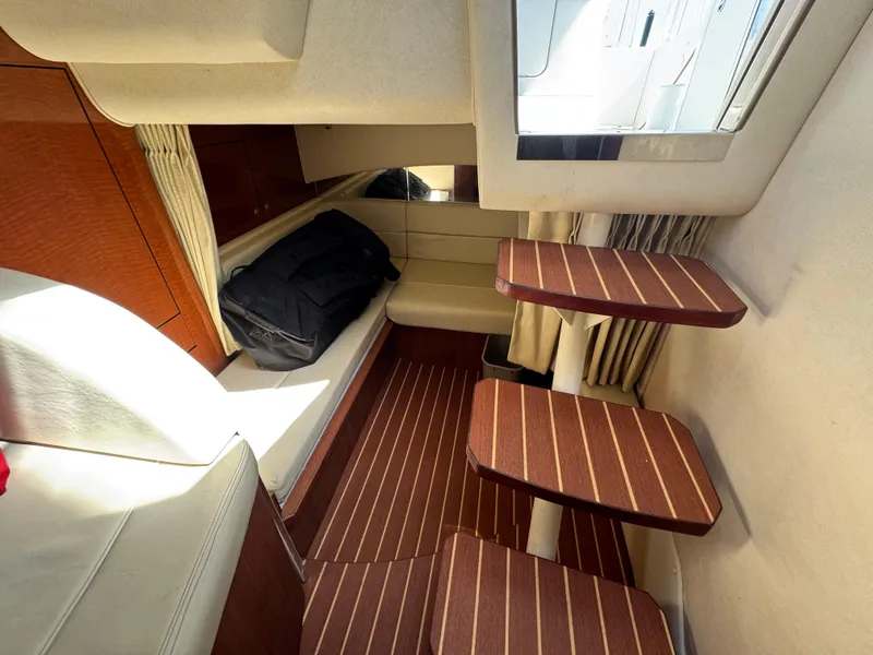 Slide: The Image of Interior of 2005 Sea Ray 300 Sundancer with wooden steps and seating area. - 11