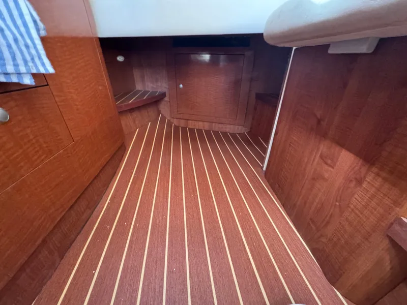 Slide: The Image of Interior of 2005 Sea Ray 300 Sundancer with wood flooring and cabinetry. - 15