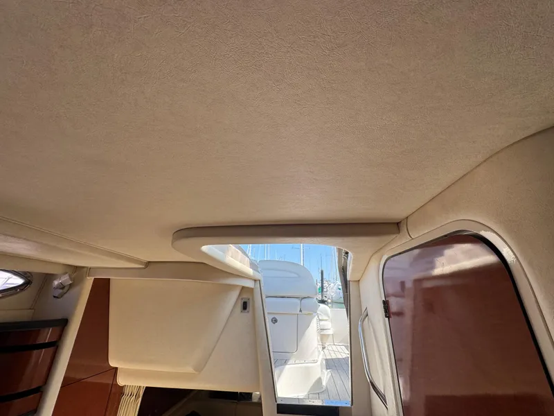 Slide: The Image of Interior view of 2005 Sea Ray 300 Sundancer yacht, showcasing cabin design and materials. - 17
