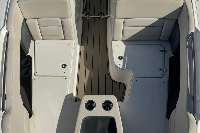 Slide: The Image of 2015 Boston Whaler 270 Vantage interior with beige seating and storage compartments. - 11