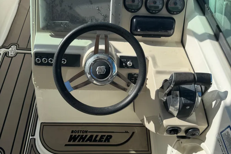 Slide: The Image of 2015 Boston Whaler 270 Vantage helm with steering wheel and controls. - 5