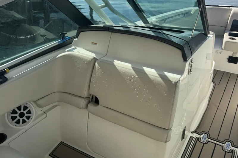 Slide: The Image of 2015 Boston Whaler 270 Vantage interior with beige seating and water droplets. - 6