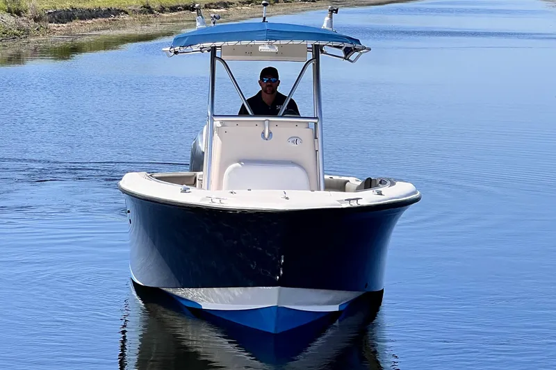Slide: The Image of 2004 Grady-White 257 Advance CC boat cruising on calm water. - 12