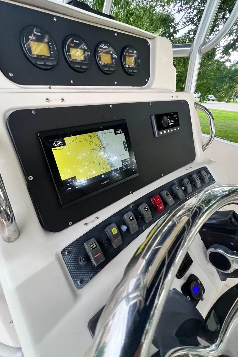 Slide: The Image of 2004 Grady-White 257 Advance CC boat dashboard with navigation system and control panel. - 2