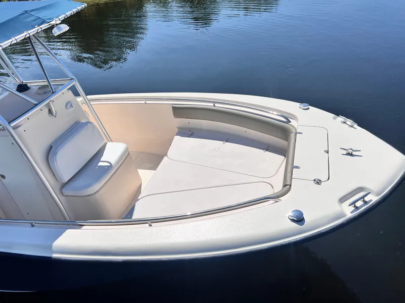 Slide: The Image of 2004 Grady-White 257 Advance CC boat on calm water, featuring a spacious deck and seating. - 7