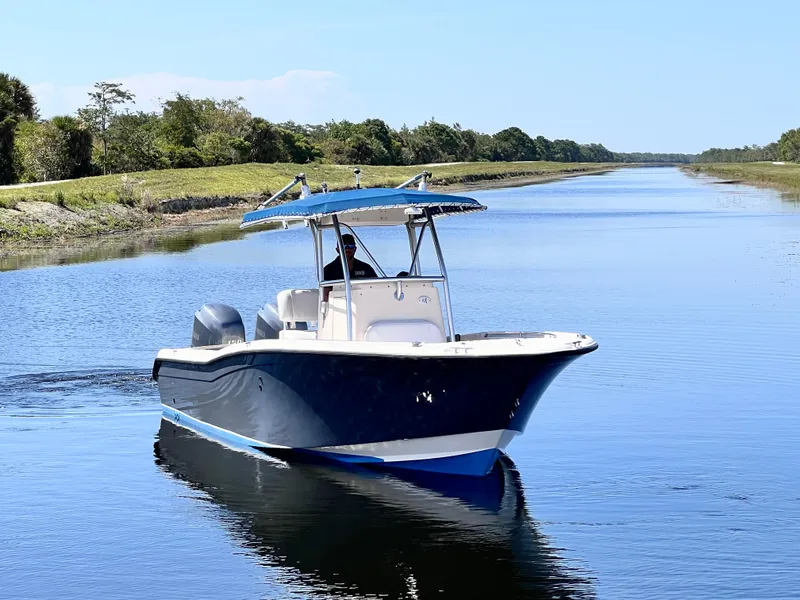 Slide: The Image of 2004 Grady-White 257 Advance CC boat cruising on a calm river. - 8