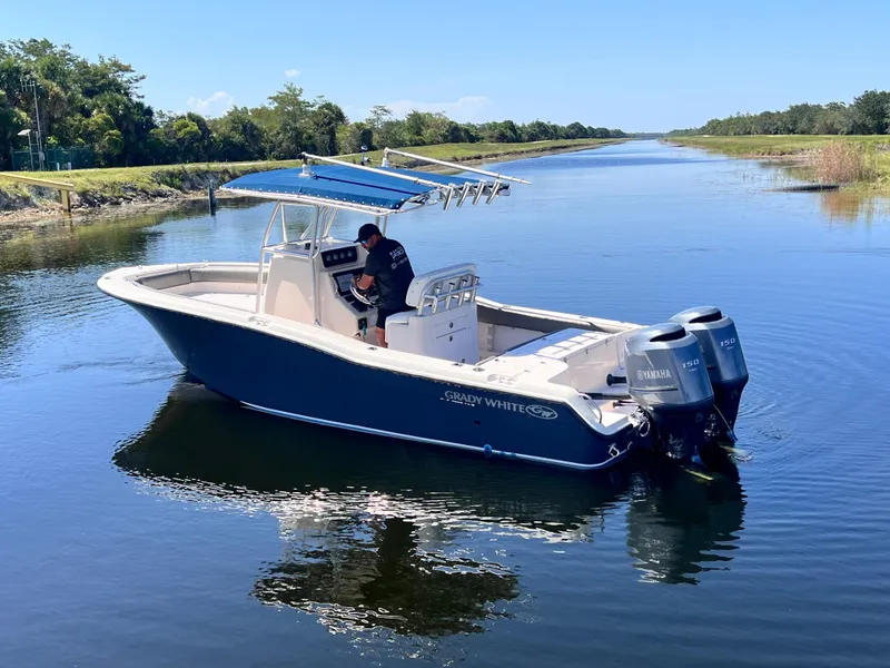 Slide: The Image of 2004 Grady-White 257 Advance CC boat on calm water with dual Yamaha engines. - 9