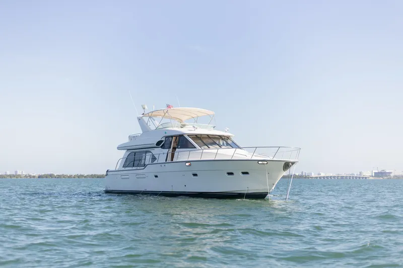 The Image of 1999 Bayliner 5788 yacht cruising on calm waters under clear blue sky. - 0