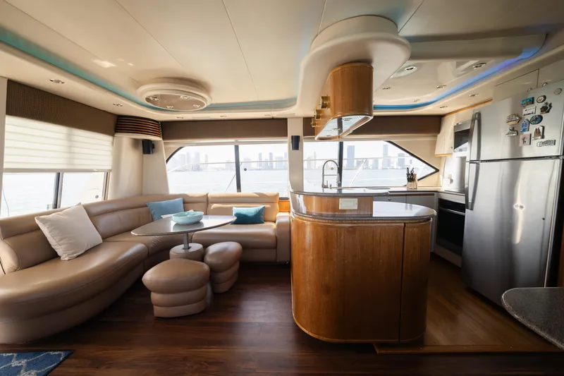 Slide: The Image of Luxurious interior of a 1999 Bayliner 5788 yacht with modern kitchen and seating area. - 10