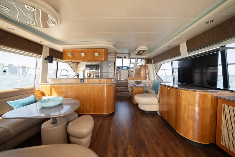 Slide: The Image of Luxurious interior of a 1999 Bayliner 5788 yacht with modern amenities and elegant wood finishes. - 11
