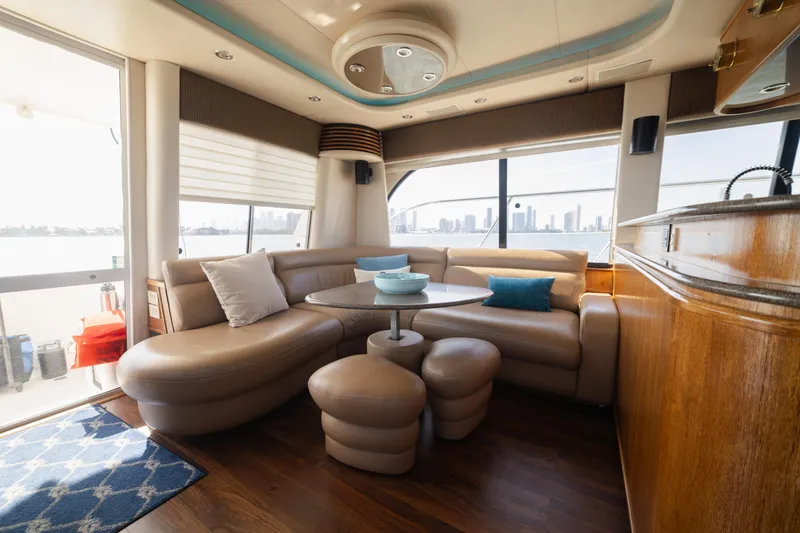 Slide: The Image of Luxurious interior of a 1999 Bayliner 5788 yacht with plush seating and city skyline view. - 13