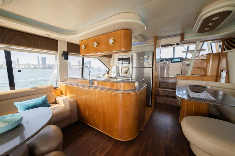 Slide: The Image of Luxurious 1999 Bayliner 5788 yacht interior with modern kitchen and seating area. - 15