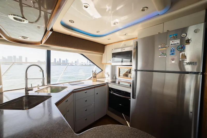 Slide: The Image of Modern kitchen interior on a 1999 Bayliner 5788 yacht with city skyline view. - 18