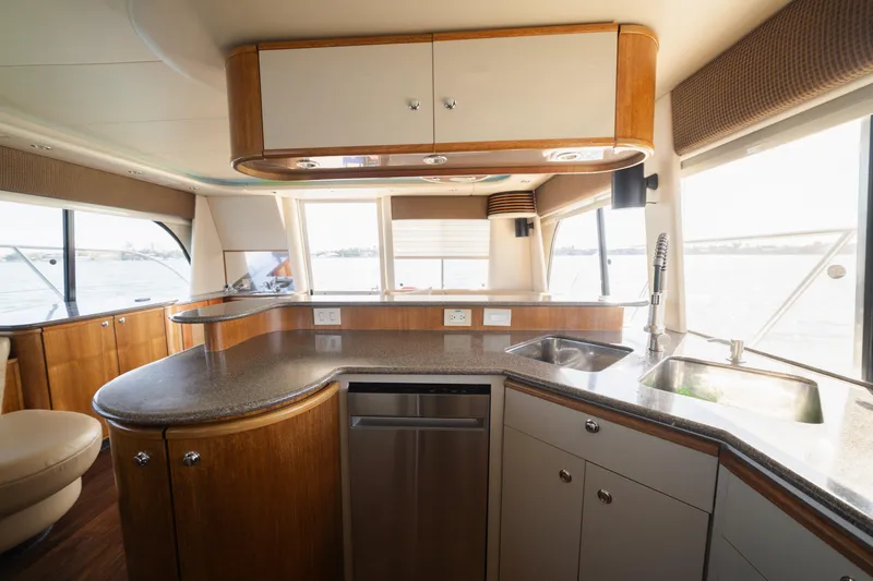 Slide: The Image of Interior of 1999 Bayliner 5788 yacht kitchen with modern fixtures and panoramic windows. - 19