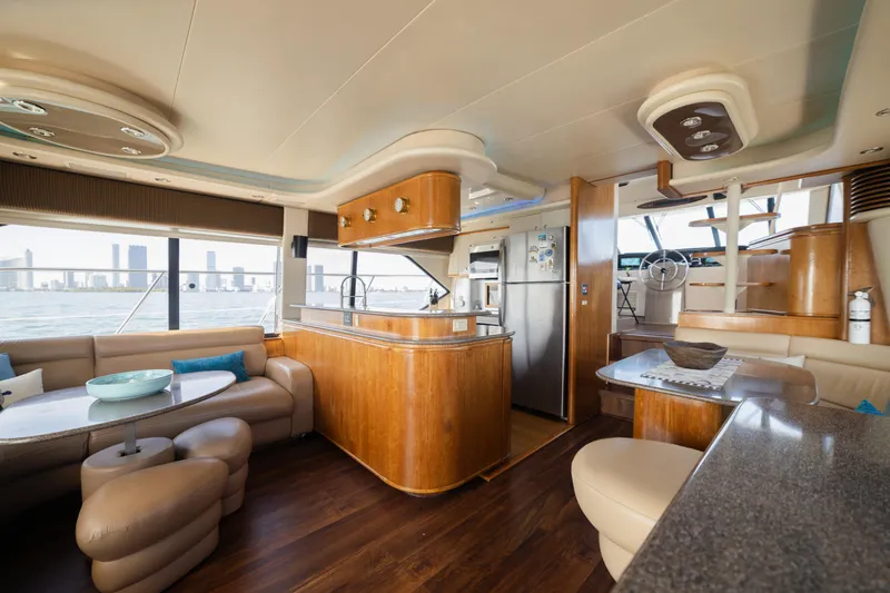 Slide: The Image of Luxurious 1999 Bayliner 5788 yacht interior with modern kitchen and seating area. - 22