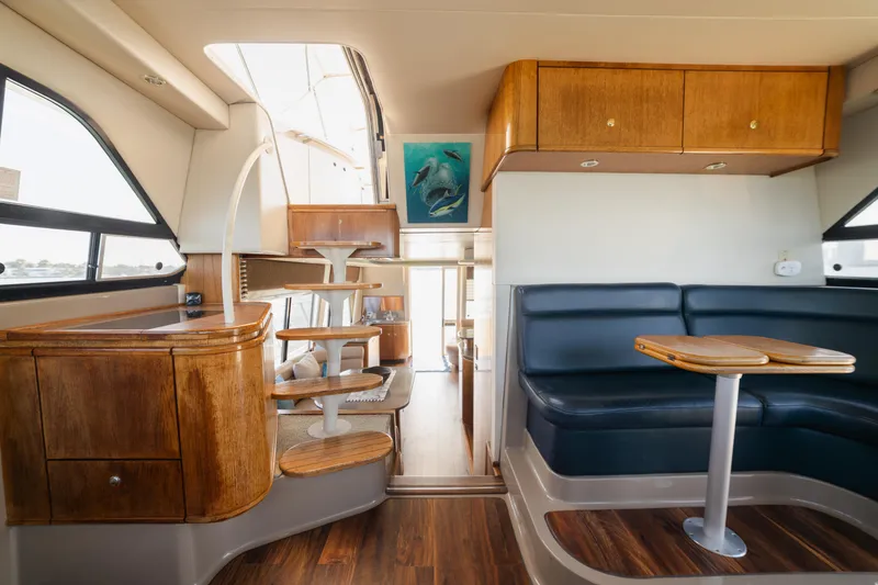 Slide: The Image of Interior of 1999 Bayliner 5788 yacht with wooden cabinetry and blue seating. - 27