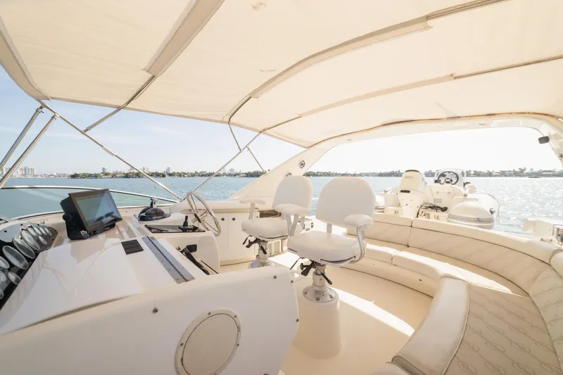 Slide: The Image of 1999 Bayliner 5788 yacht interior with helm, seating, and ocean view. - 30