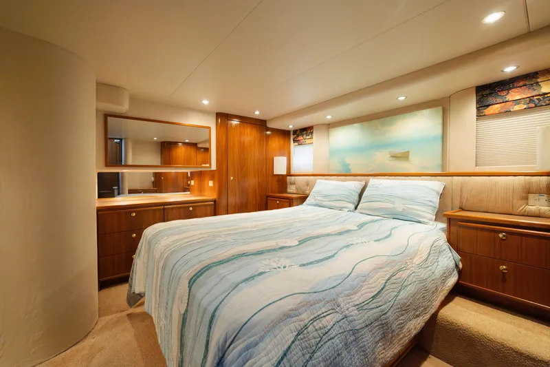 Slide: The Image of Luxurious bedroom interior of 1999 Bayliner 5788 yacht with elegant wood furnishings. - 35