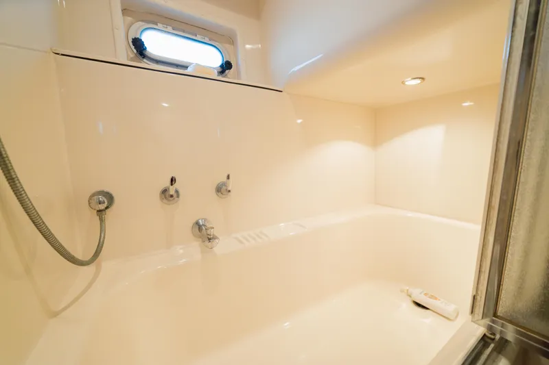 Slide: The Image of Luxurious bathroom in 1999 Bayliner 5788 yacht with modern fixtures and natural lighting. - 37