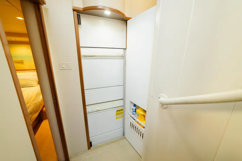 Slide: The Image of Laundry area in 1999 Bayliner 5788 yacht with stacked washer and dryer. - 38