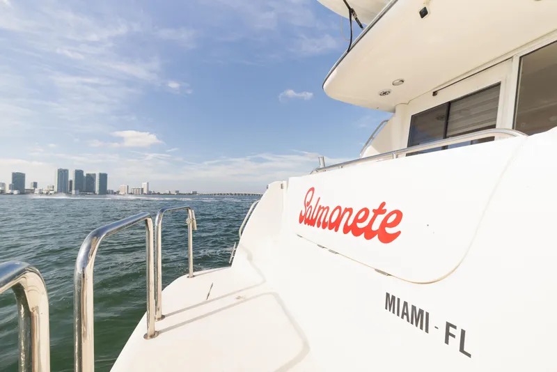 Slide: The Image of 1999 Bayliner 5788 yacht named Salmonete, docked in Miami, Florida, with city skyline view. - 4