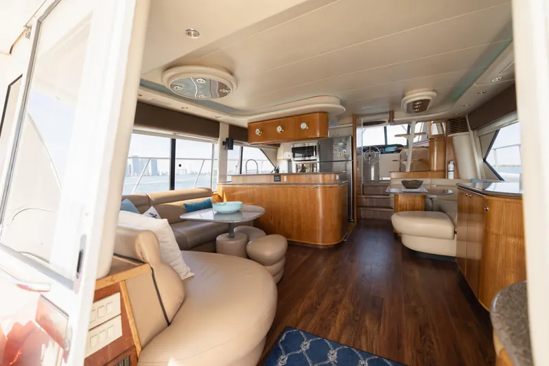 Slide: The Image of Luxurious interior of a 1999 Bayliner 5788 yacht with modern furnishings and wood accents. - 8