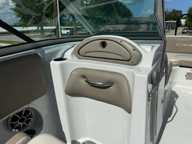 Slide: The Image of 2022 Crownline Eclipse E215 XS boat interior with beige accents and speaker detail. - 10