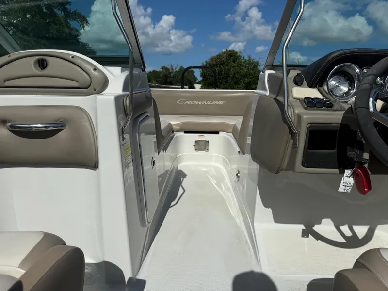 Slide: The Image of 2022 Crownline Eclipse E215 XS boat interior with steering wheel and seating. - 11