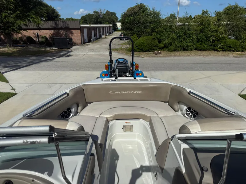 Slide: The Image of 2022 Crownline Eclipse E215 XS boat interior with beige seating and speakers. - 12