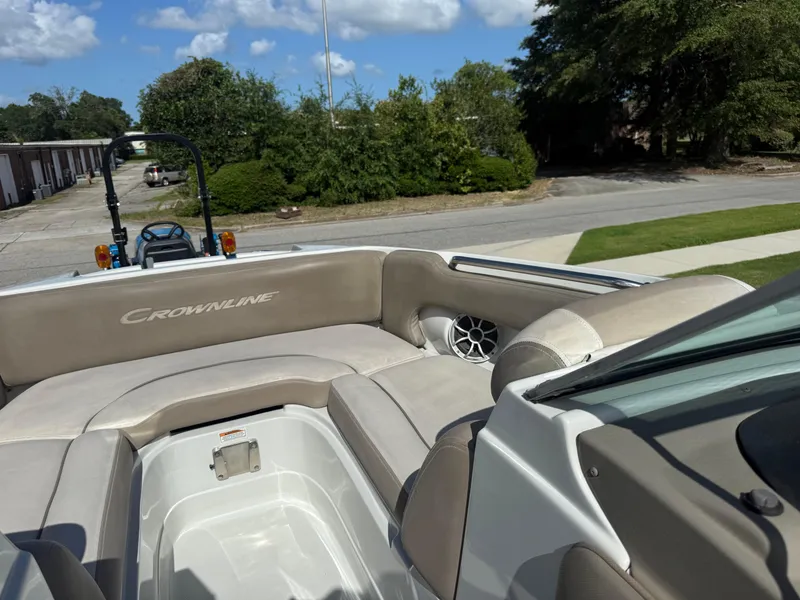Slide: The Image of 2022 Crownline Eclipse E215 XS boat interior with beige seating and speaker. - 14