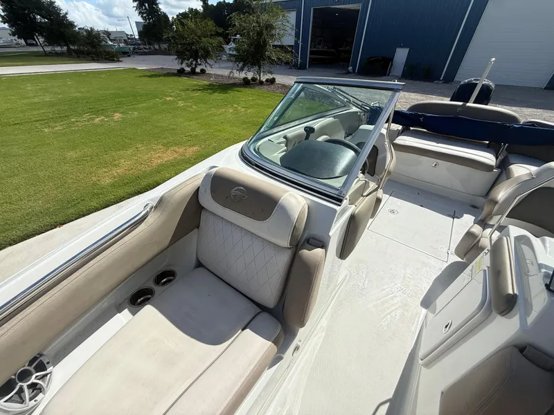 Slide: The Image of 2022 Crownline Eclipse E215 XS boat interior with beige seating and open deck. - 15