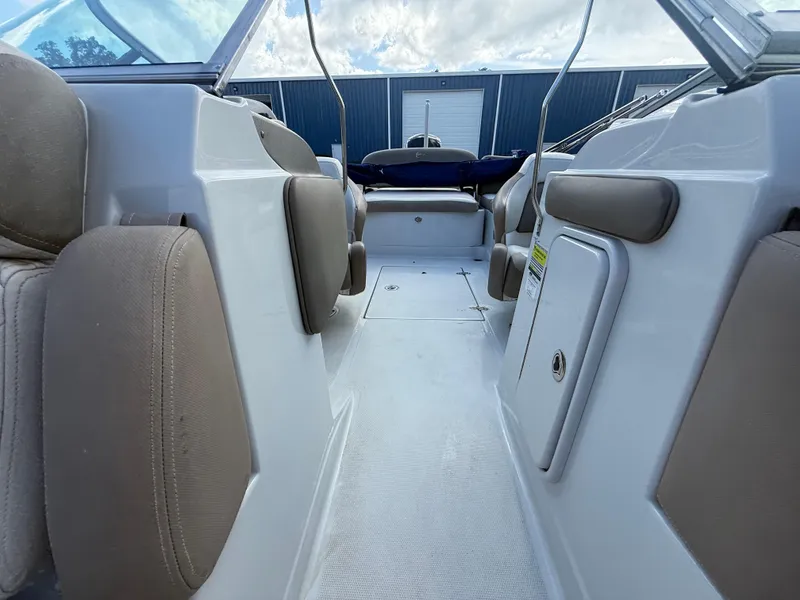 Slide: The Image of 2022 Crownline Eclipse E215 XS boat interior with cushioned seating and storage compartments. - 17